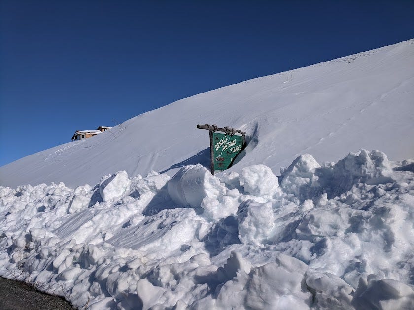 a business sign buried in the snow