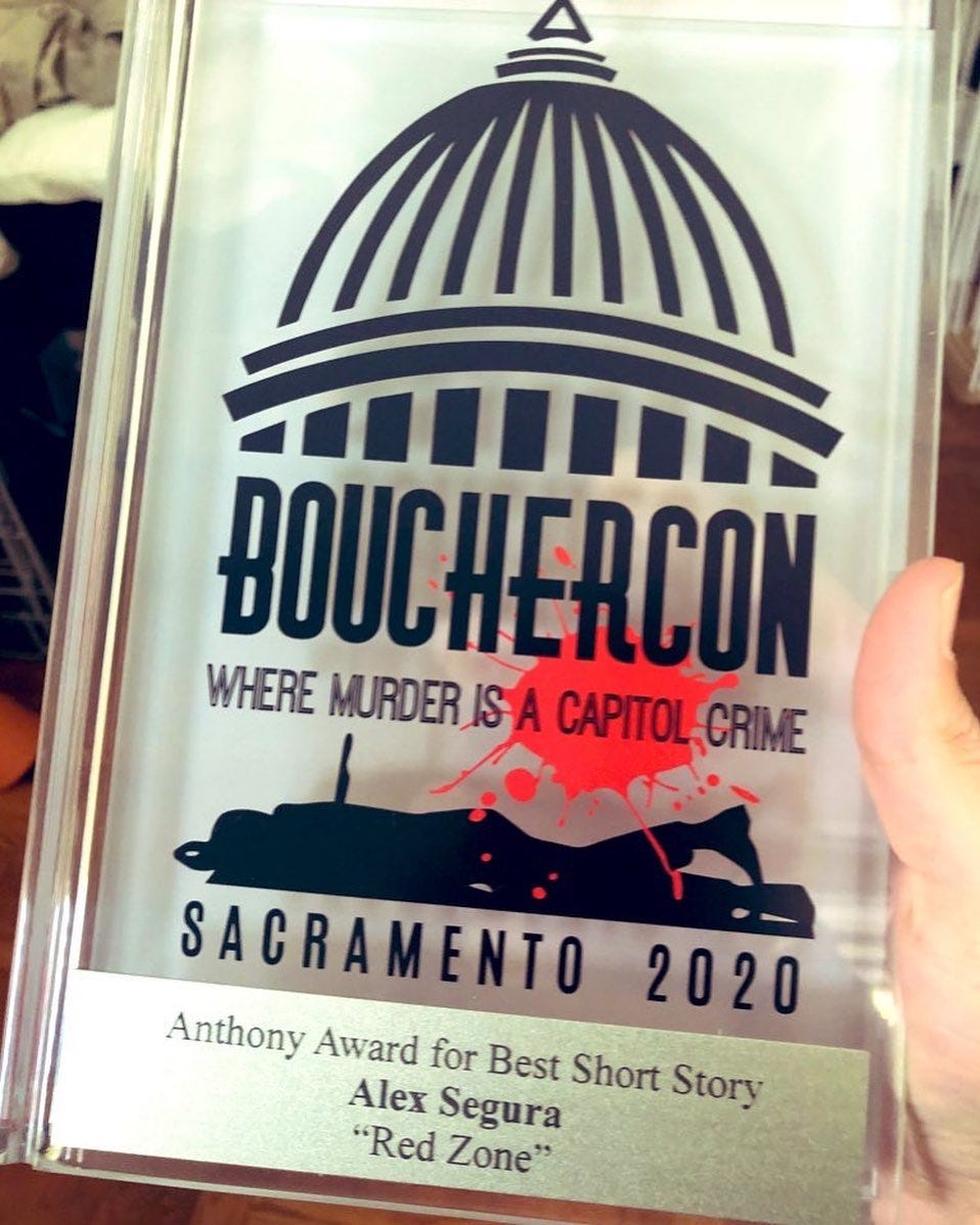 Image may contain: text that says 'BOUCHERCON WHERE MURDER_ISA CAPITOL CRIME SACRAMENTO 2020 Anthony Award for Best Short Story Alex Segura "Red Zone"'