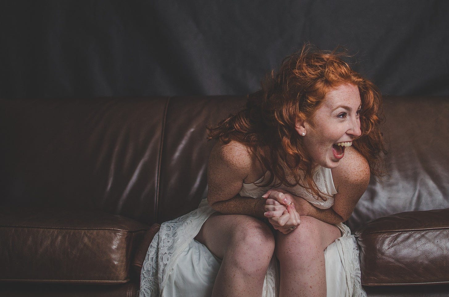 woman with red hair laughing