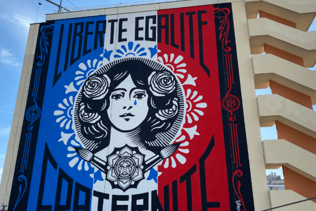 Shepard Fairey Marianne liberté égalité fraternité street art on side of building 