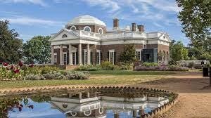 A white house with a pond in front of it

Description automatically generated with low confidence