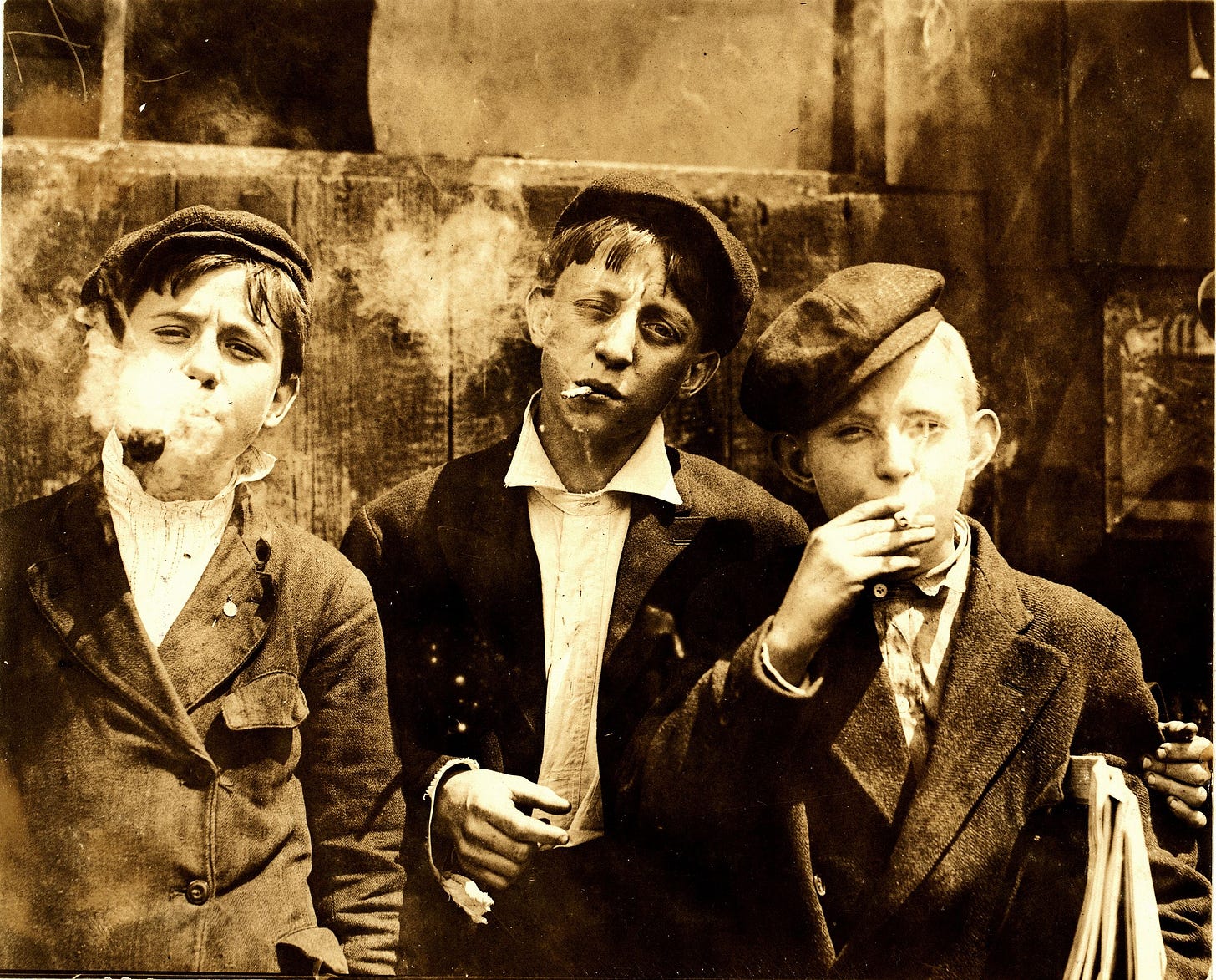 Lewis Hine, Newsies smoking at Skeeter's Branch, St. Louis, 1910.jpg