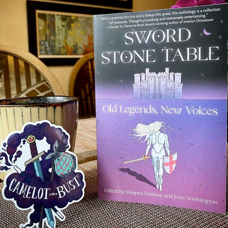 Sword Stone Table sitting on a table next to a sticker that says, "Camelot or Bust"