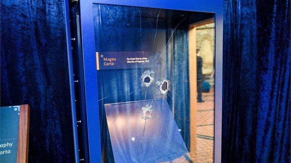 Hammer holes in the glass case that houses the Magna Carta