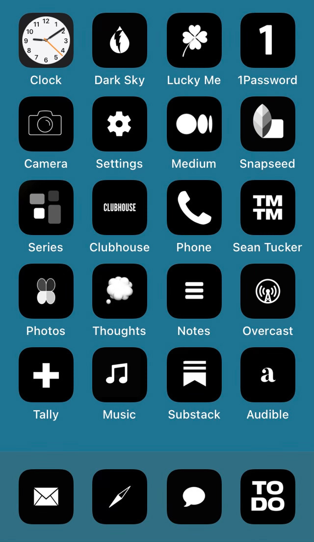 A screenshot of the author's iPhone home screen is shown. The app icons are all black with white and the screen background is blue.