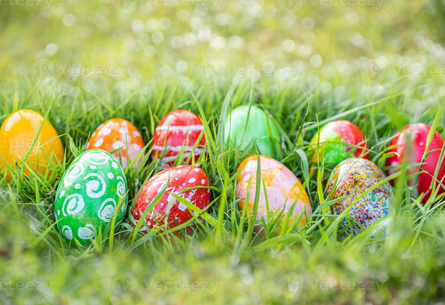 closeup, many beautiful painted easter eggs as grass blurred background.  concept for good friday, easter monday, spring full moon. copy space on top  for text or design. garden, nobody, selective focus 6481521