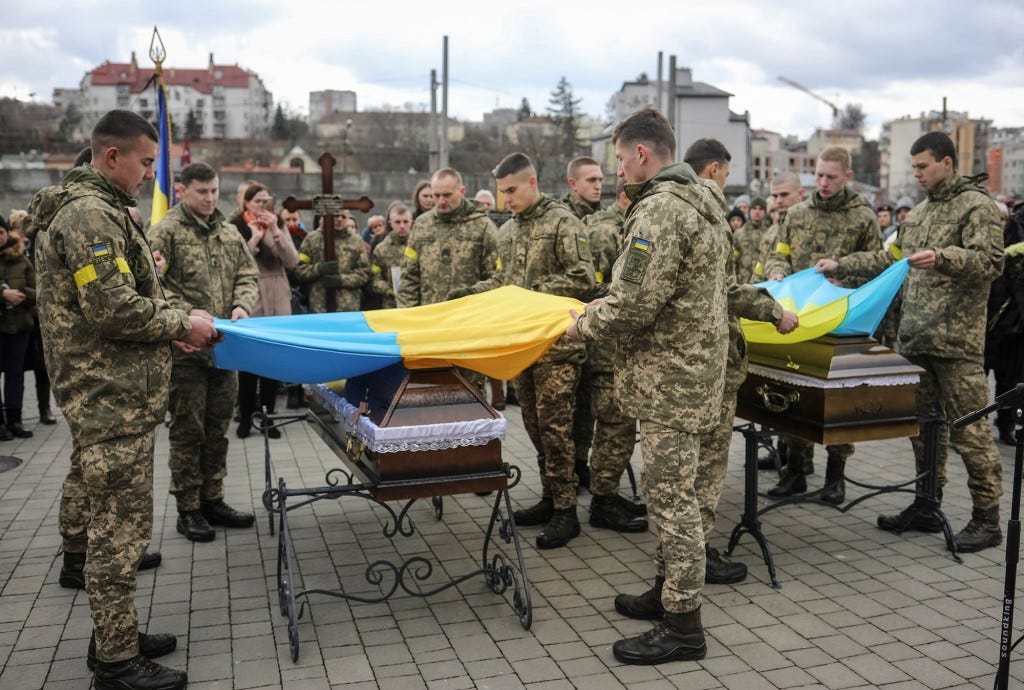 A joint funeral takes place at 'Saint's Peter and Paul Garrison Church', for two soldiers who died in the east of the country during recent fighting.