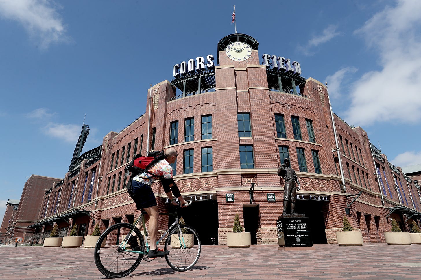 A cyclist passes Coors Field in Denver, Colorado. 