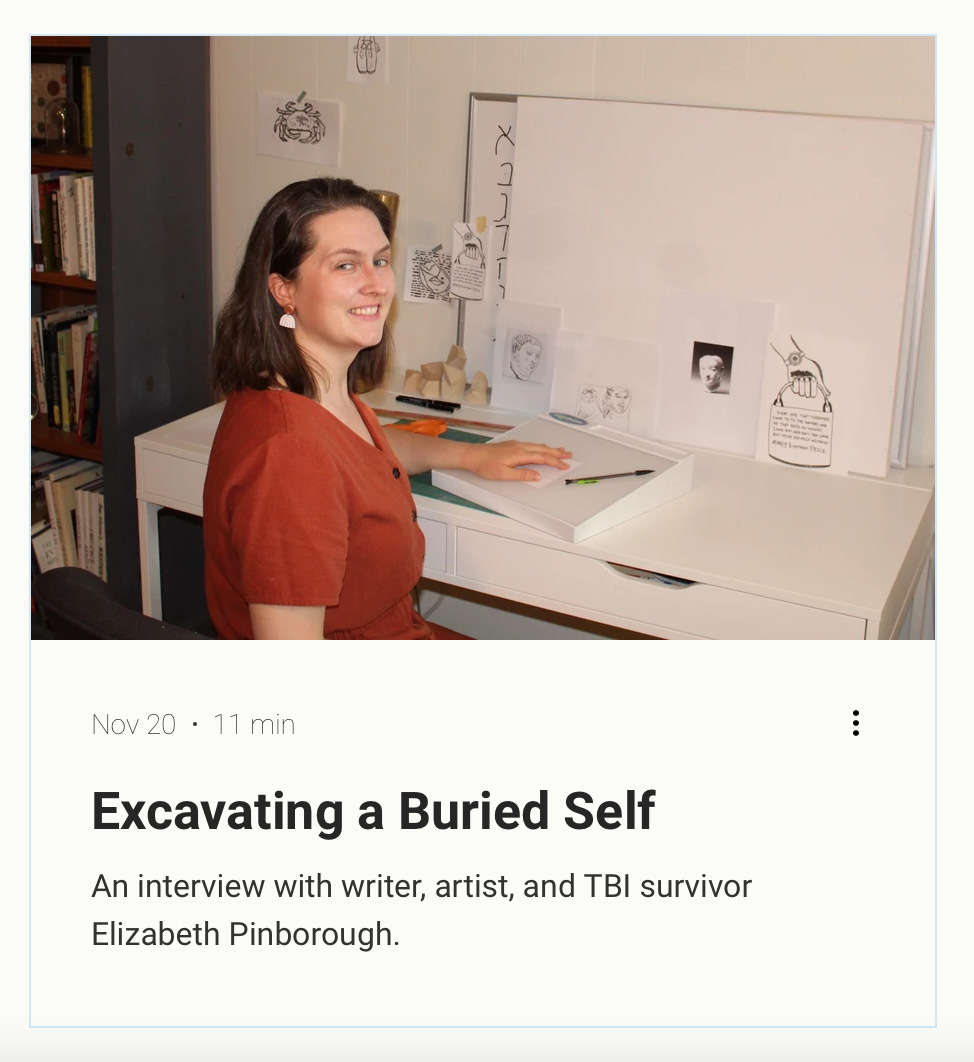 Excavating a Buried Self, an interview with writer, artist, and TBI survivor Elizabeth Pinborough. Photo of the author wearing a rust-colored jumpsuit at a white desk with black and white linocuts on the walls. 