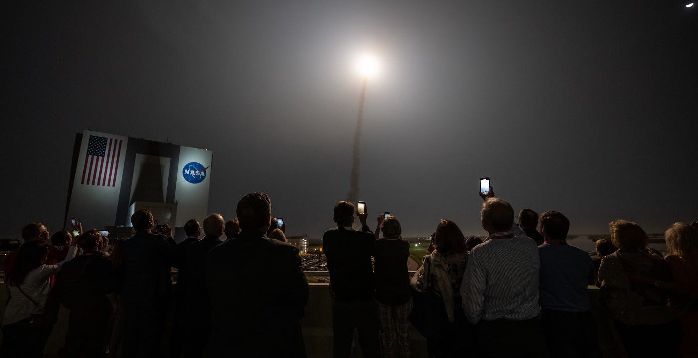 Guests watch the launch of NASA’s Space Launch System rocket carrying the Orion spacecraft on the Artemis I flight test, Wednesday, Nov. 16, 2022, from Operations and Support Building II at NASA’s Kennedy Space Center in Florida. NASA’s Artemis I flight test is the first integrated flight test of the agency’s deep space exploration systems: the Orion spacecraft, Space Launch System (SLS) rocket, and ground systems. SLS and Orion launched at 1:47 a.m. EST, from Launch Pad 39B at the Kennedy Space