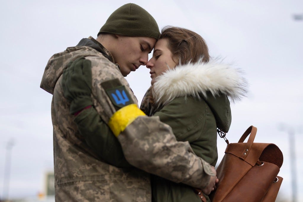 Ukrainian Olga Shmigal says goodbye to her partner Vladimir Golyadynets before boarding a train to Dnipro.