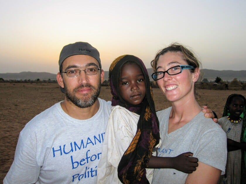 Gabriel Stauring and Katie-Jay Scott hold Darfuri refugee Guisma in Eastern Chad in 2009