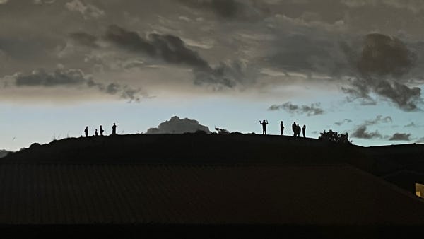 As a violent storm approached, people climbed a hill to watch. A metaphor for our times?  