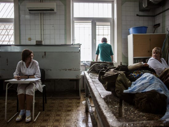 Ukrainian medical staff prepare to clean the body of a killed pro-Russian fighter at the Kalinina morgue in the eastern Ukrainian city of Donetsk, on May 27, 2014. Ukraine said today it had regained control of the airport in the eastern city of Donetsk after a day of punishing air strikes and fierce fighting with pro-Moscow separatist gunmen left dozens of people dead. AFP PHOTO / FABIO BUCCIARELLIFABIO BUCCIARELLI/AFP/Getty Images