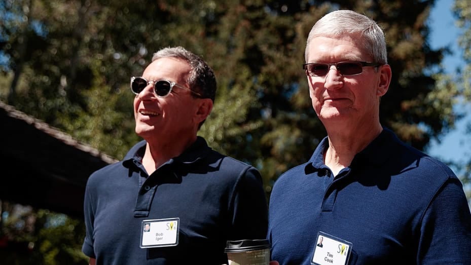 Bob Iger, chief executive officer of The Walt Disney Company, walks with Tim Cook, chief executive officer of Apple Inc., as they attend the annual Allen & Company Sun Valley Conference, July 6, 2016 in Sun Valley, Idaho.