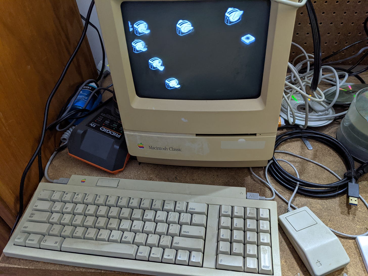 A Mac Classic personal computer with keyboard and mouse, sitting on a desk. A Mac Classic personal computer with keyboard and mouse, sitting on a desk.