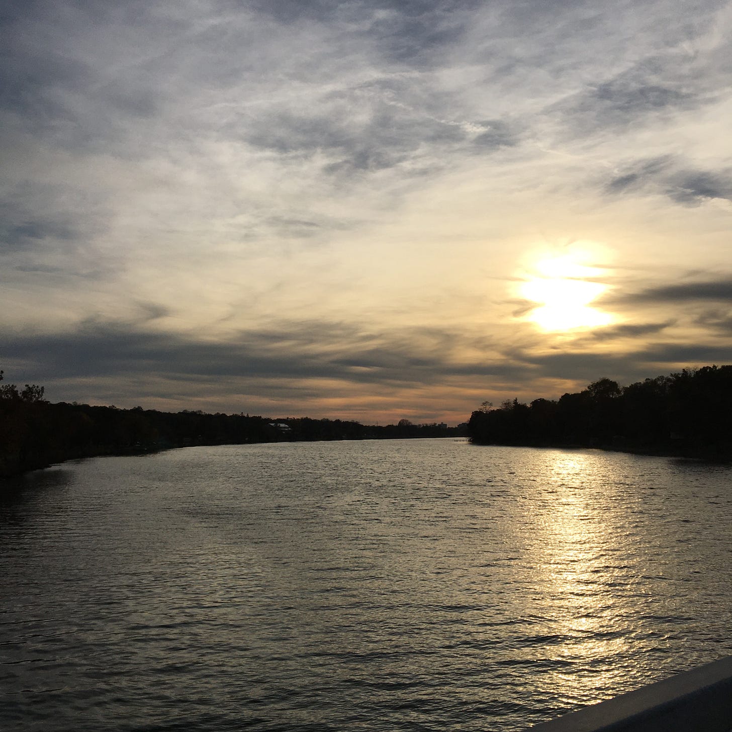 the sun setting over a river