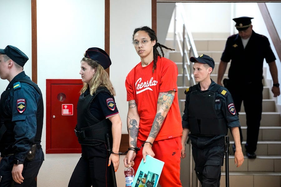 WNBA star and two-time Olympic gold medalist Brittney Griner is escorted to a courtroom for a hearing, in Khimki just outside Moscow, Russia, Thursday, July 7, 2022. Jailed American basketball star Brittney Griner returns to a Russian court on Thursday amid a growing chorus of calls for Washington to do more to secure her release nearly five months after being arrested on drug charges. (AP Photo/Alexander Zemlianichenko) ORG XMIT: XAZ107