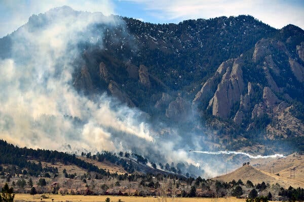 An air tanker over the NCAR fire near the National Center for Atmospheric Research on Saturday in Boulder, Colo.