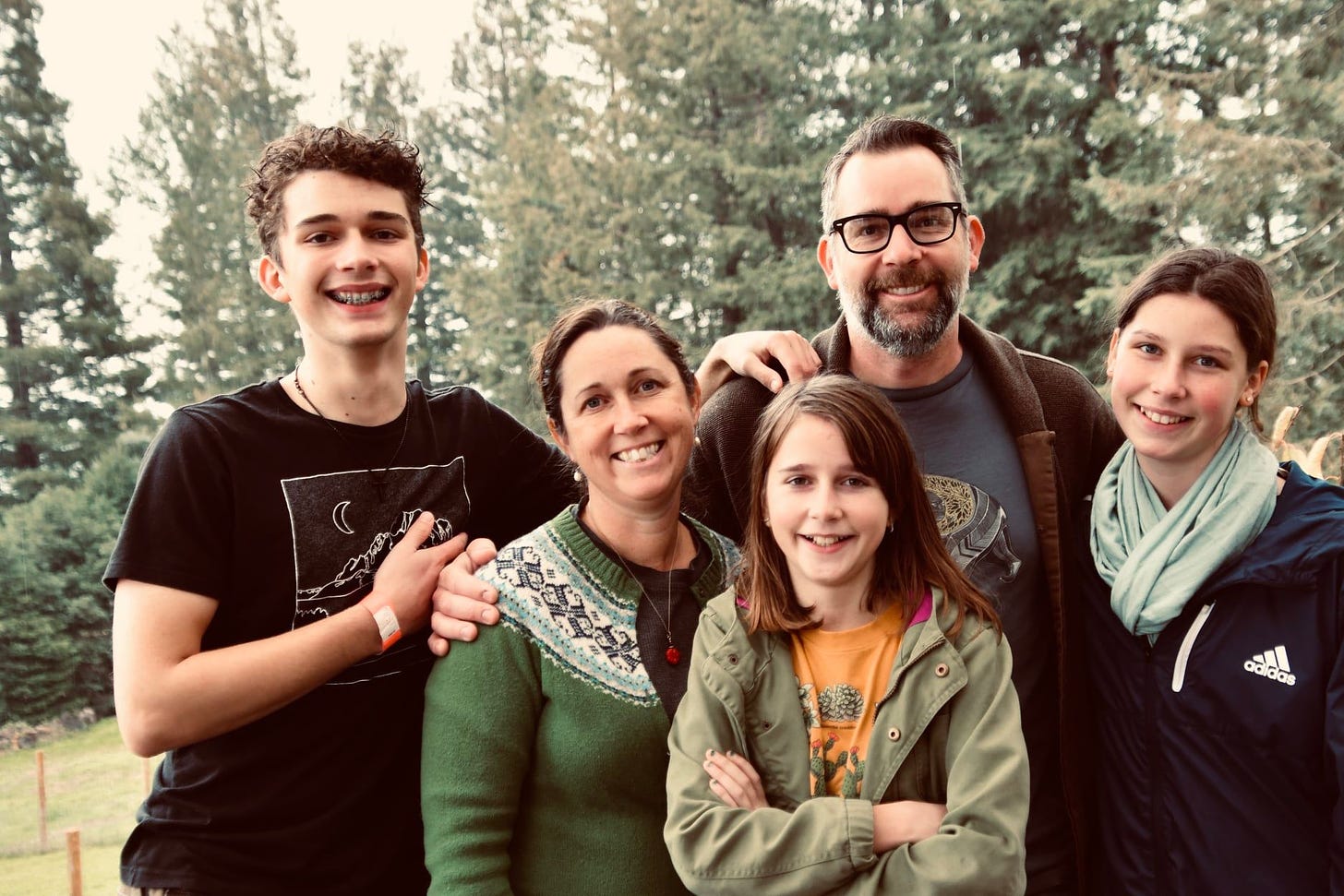 May be an image of 4 people, people standing, outdoors and tree