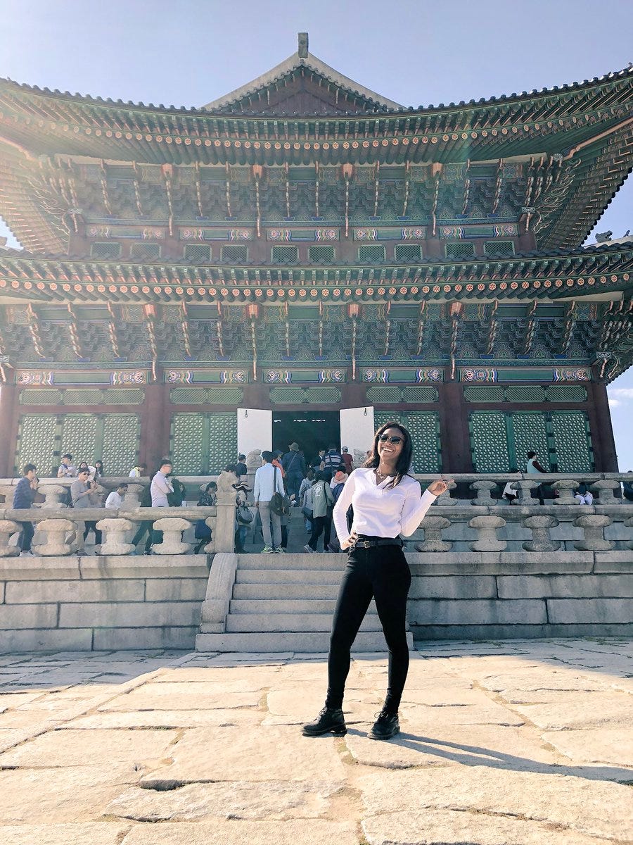 Kat standing in front of the throne room of Gyeongbokgung Palace in Seoul, South Korea.