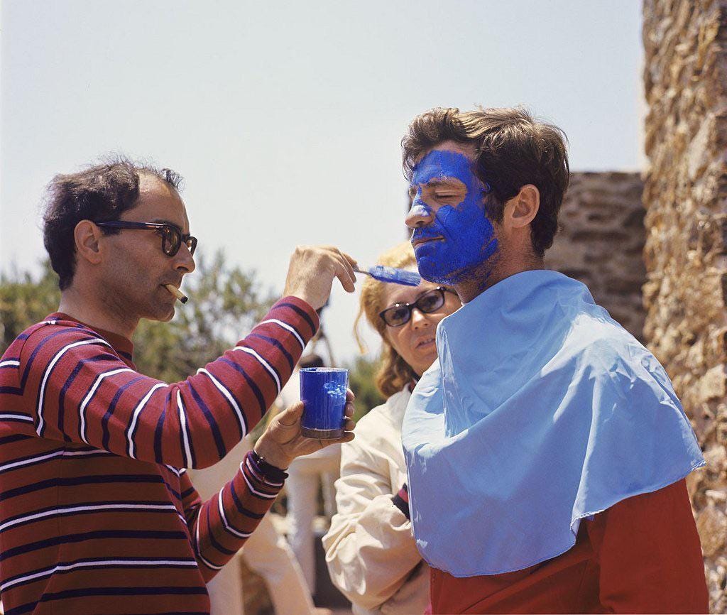 Godard paints Jean-Paul Belmondo's face during the filming of Pierrot le Fou,  1965 : r/Moviesinthemaking