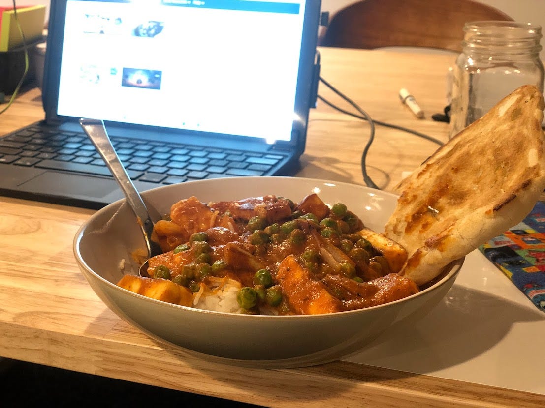 a photo of the completed dish in front of a blurry laptop.