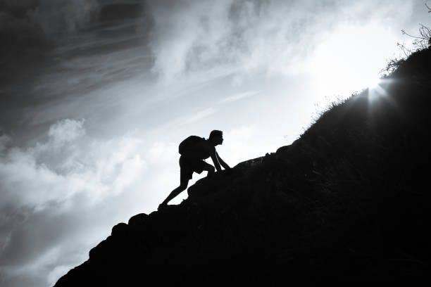 Man climbing up a mountain. Black and white image of man climbing up a mountain. Climb Mountain stock pictures, royalty-free photos & images