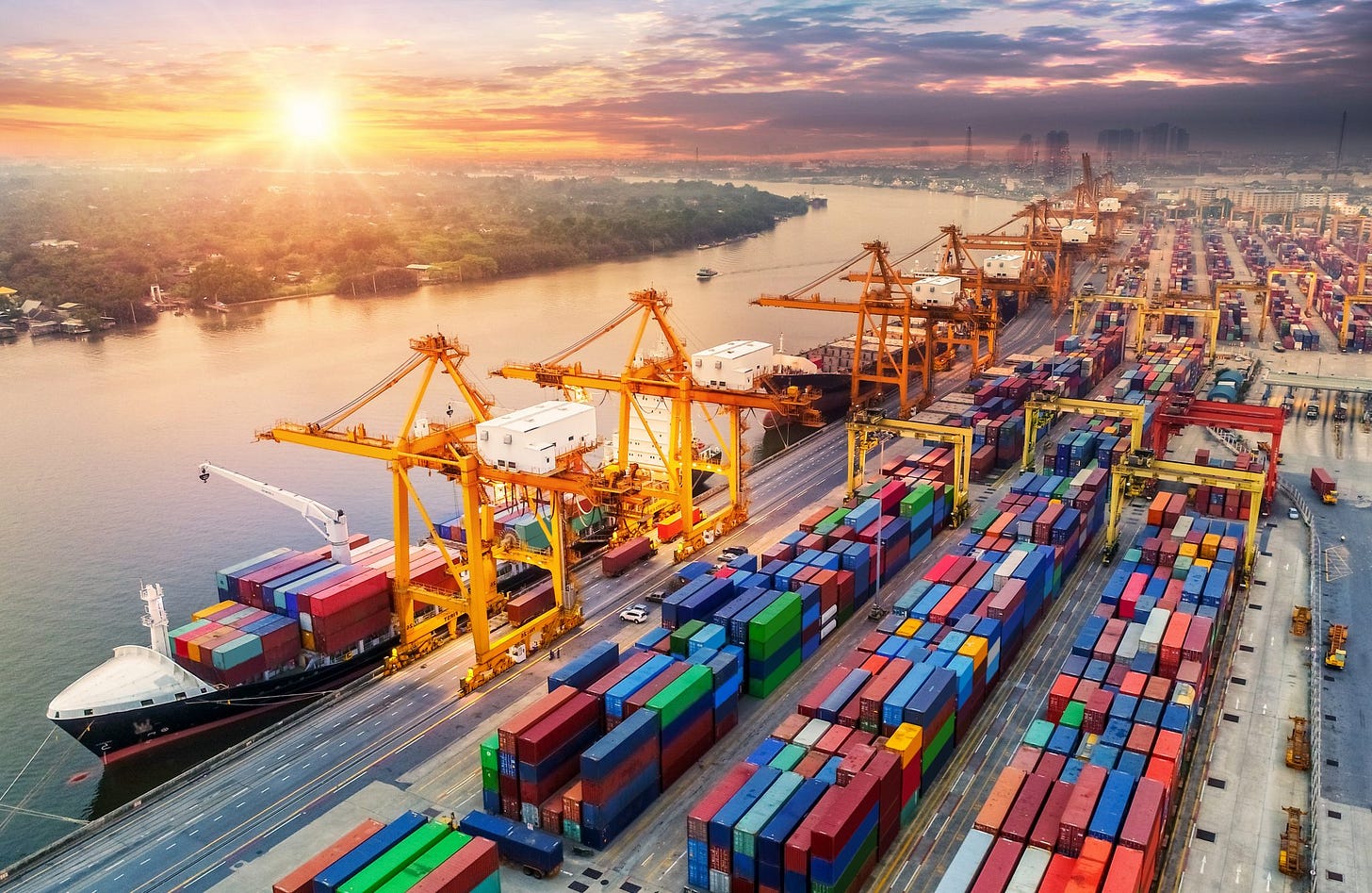 The sun rises over a colorful container yard. The sun rises over a colorful container yard.