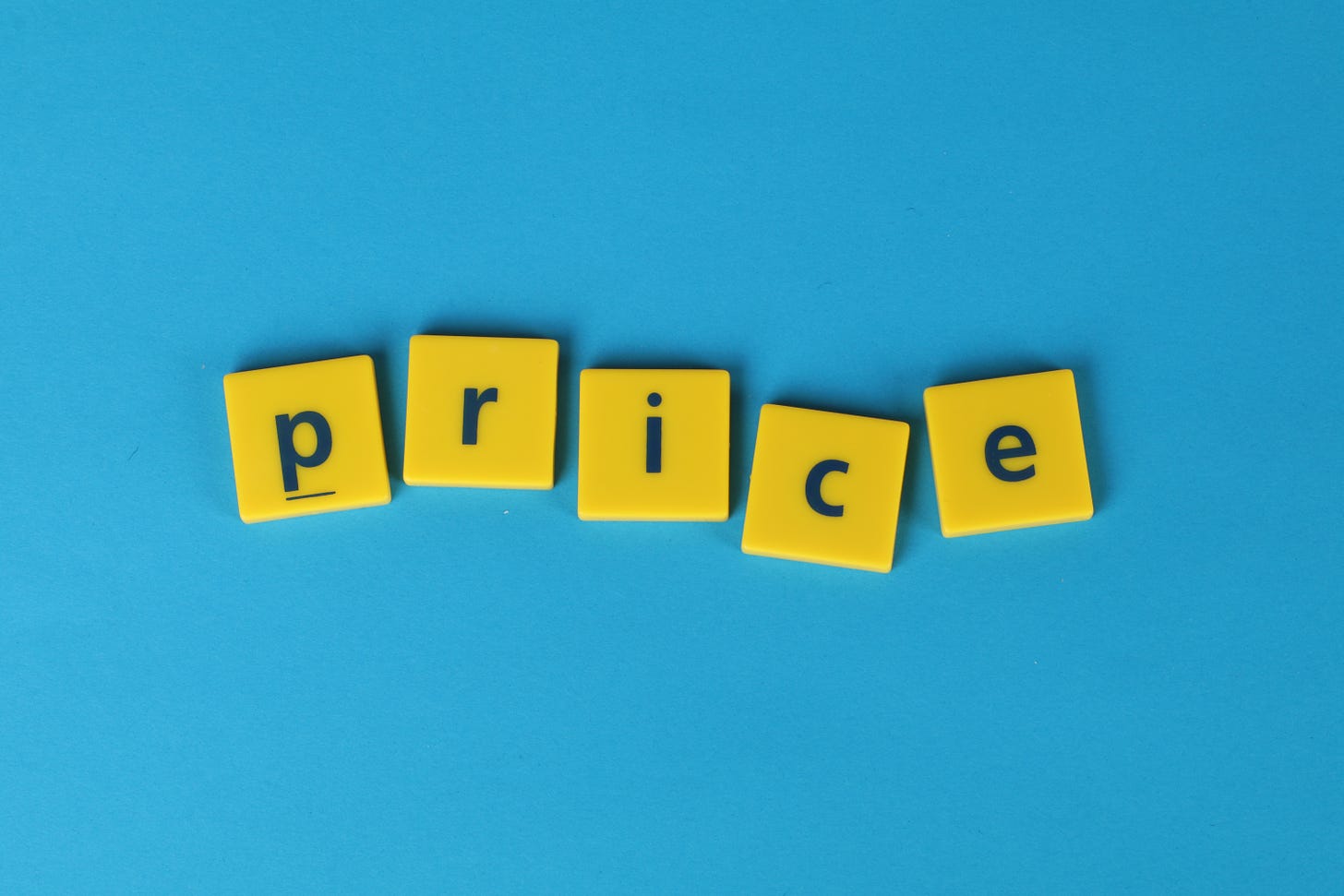 Yellow Scrabble letters that spell out "price."