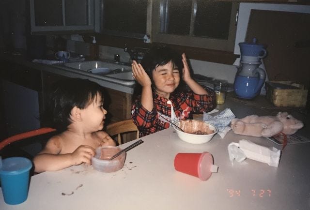 baby mia covering her ears while baby frankie looks on