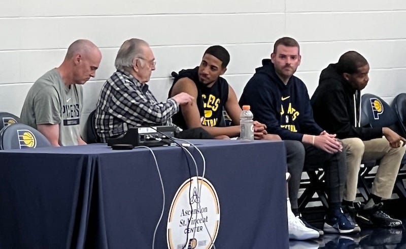 Pacers guard Tyrese Haliburton talks with former team executive Donnie Walsh after practice on Friday.