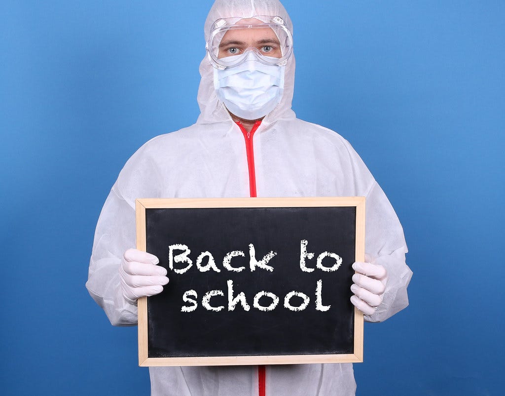 Doctor with a blackboard and message Back to School