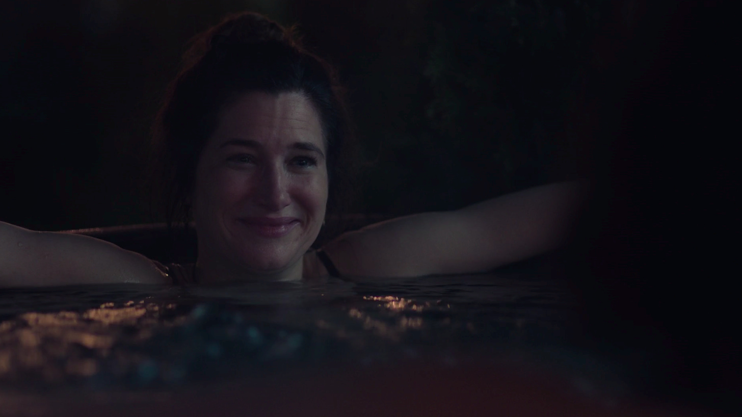 A dark image of Hahn smiling while in a hot tub