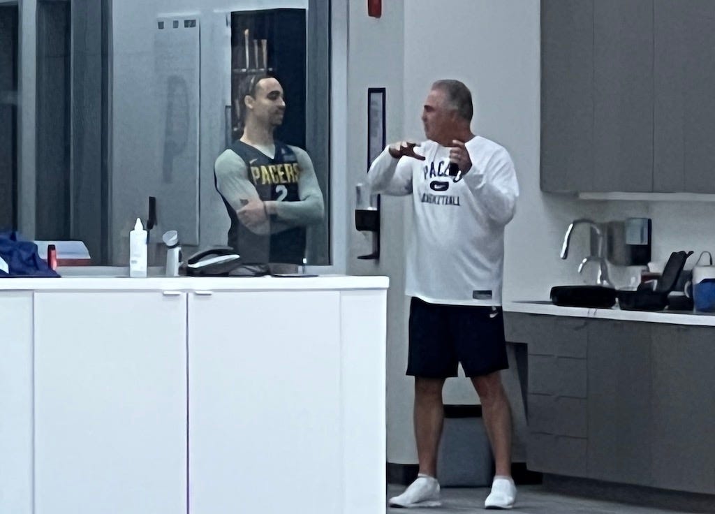 Team president Kevin Pritchard talks with second-round pick Andrew Nembhard after a training camp practice.