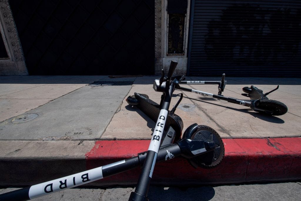 Bird scooters strewn on a street in California.
