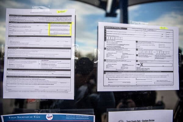 Sample voting forms are taped to a window. Travis County election officials said that due to the new Texas voting law, half of vote-by-mail applications for March primaries had been rejected in Austin.