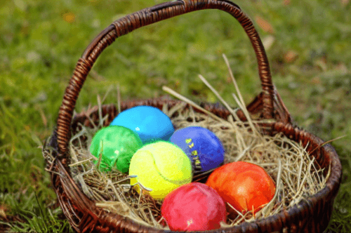 Easter basket of eggs with the yellow egg replaced by a tennis ball