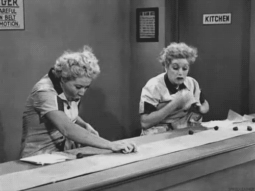 Lucy and Ethel overwhelmed by speeding chocolates in the chocolate factory.