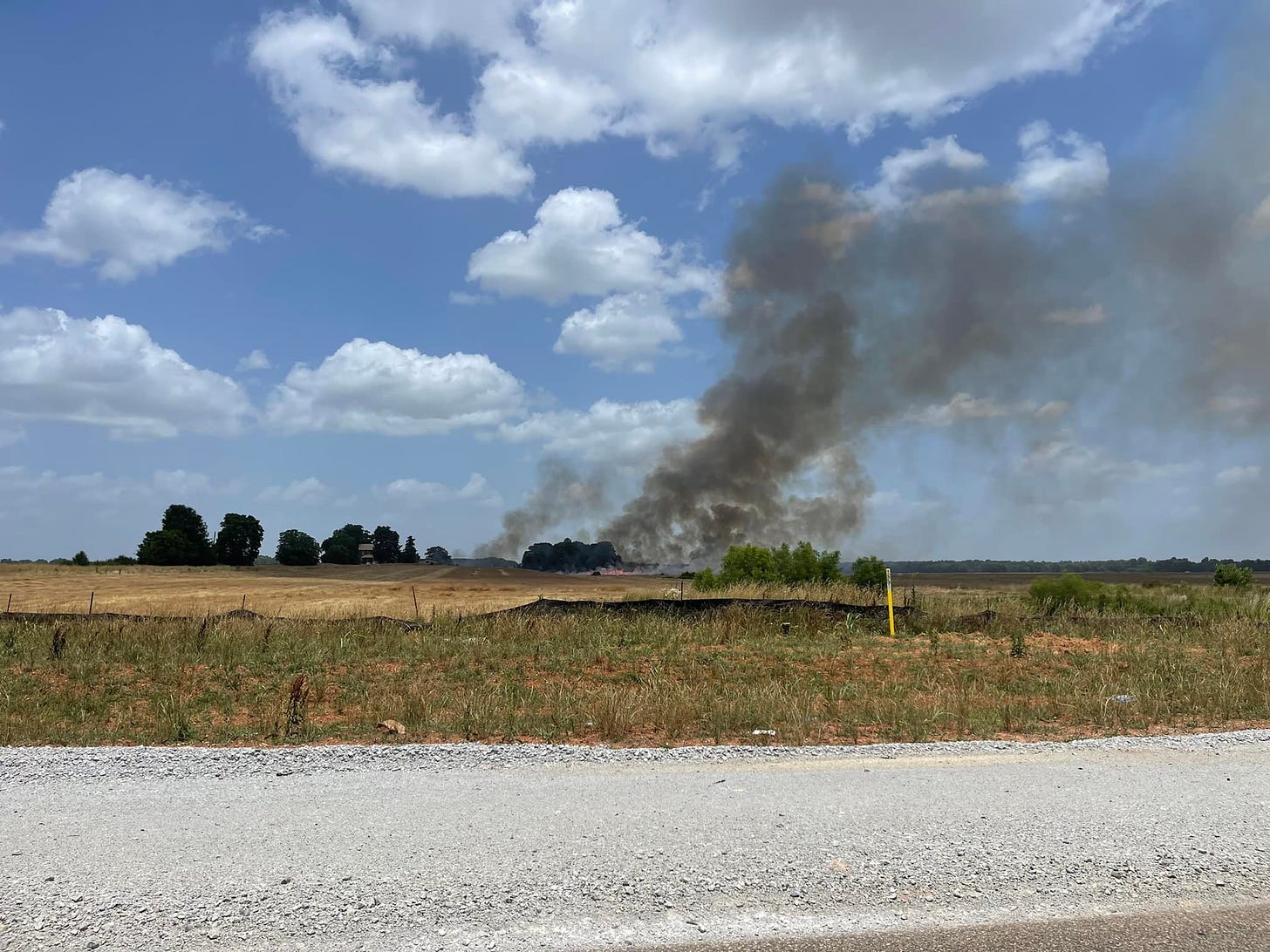 A fire burning in a pasture. 