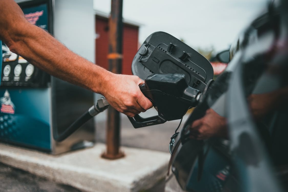 Free Person Putting Gasoline on a Vehicle Stock Photo