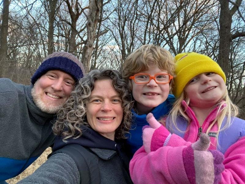 In this 2022 provided by the Schmidt and Morehead families, Tyler Schmidt, left, and his wife Sarah pose with their son Arlo and daughter Lula, right, while hiking near Cedar Falls, Iowa. Police said Saturday, July 23, 2022, the Iowa couple and their 6-year-old daughter were fatally shot while camping in a state park by a man from Nebraska who later turned the gun on himself. The couple's 9-year-old son survived.  (Courtesy of the Schmidt and Morehead families)