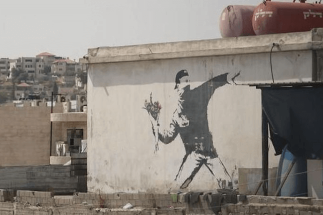 Banksy the flower thrower on wall