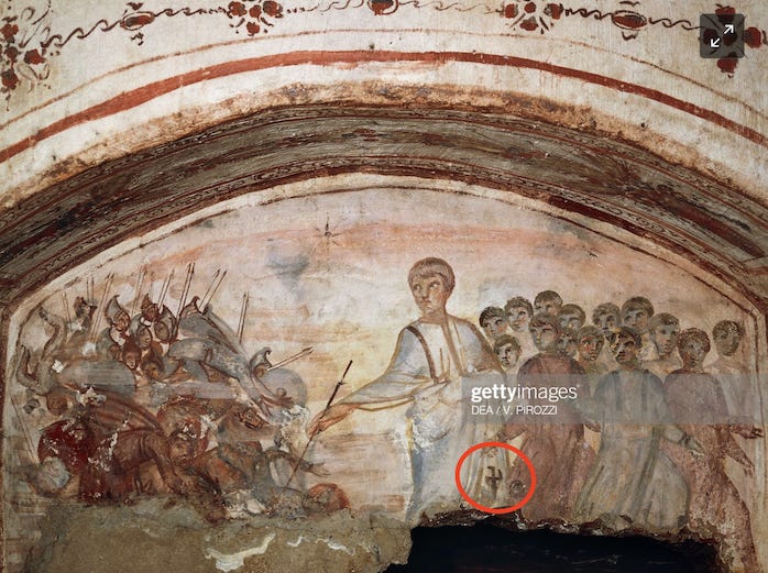 A fresco in natural tones of beige, umber, and brown. A white man with blonde hair stands in the middle of the fresco wearing white robes with a hakenkreuz symbol on the bottom right on his robes. I circled the symbol in red. A crowd behind him on the right looks on. Before him on the left is a group of people stuck with arrows. and lying on top of each other The central figure holds a stick or arrow in his hand.