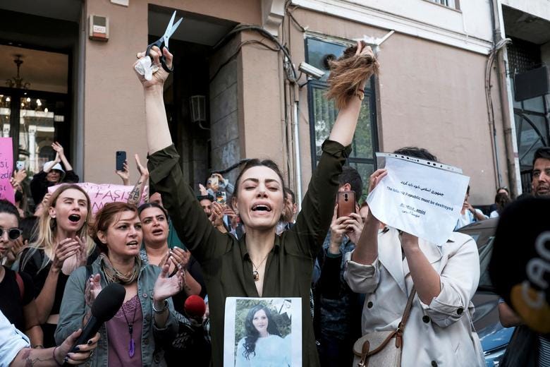 Nasibe Samsaei, an Iranian woman living in Turkey, reacts after she cut her hair during a protest following the death of Mahsa Amini, outside the Iranian consulate in Istanbul, Turkey. REUTERS/Murad Sezer