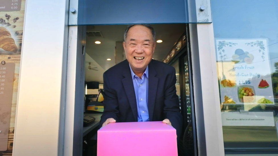 Ted with the iconic pink doughnut box he popularised