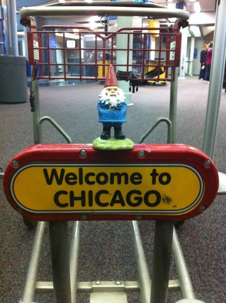 Gnome on sign that says "Welcome to Chicago"