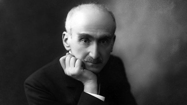 A black and white photo of Henri Bergson. He is bald and he does indeed appear to have a massive forehead