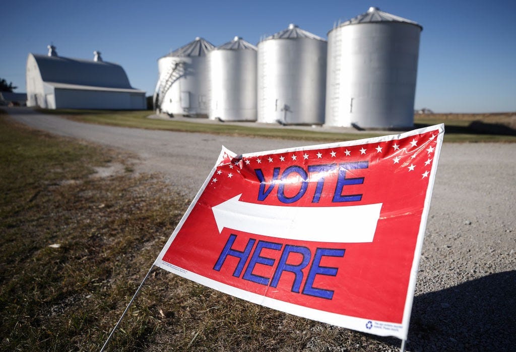 A “Vote Here” sign points voters toward a polling place in Ray Lounsberry’s shed on November 3, 2020, in Nevada, Iowa. (Photo by Mario Tama/Getty Images)