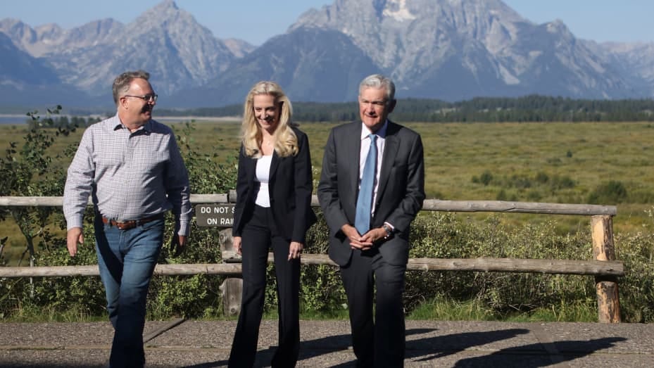 John C. Williams, president and chief executive officer of the Federal Reserve Bank of New York, Lael Brainard, vice chair of the Board of Governors of the Federal Reserve, and Jerome Powell, chair of the Federal Reserve, walk in Teton National Park where financial leaders from around the world gathered for the Jackson Hole Economic Symposium outside Jackson, Wyoming, August 26, 2022.